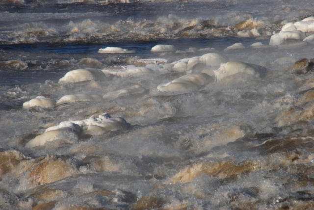 Close-up photograph of the Chain of Rocks rapids on the Mississippi River above St. Louis, with ice and steam all around them
